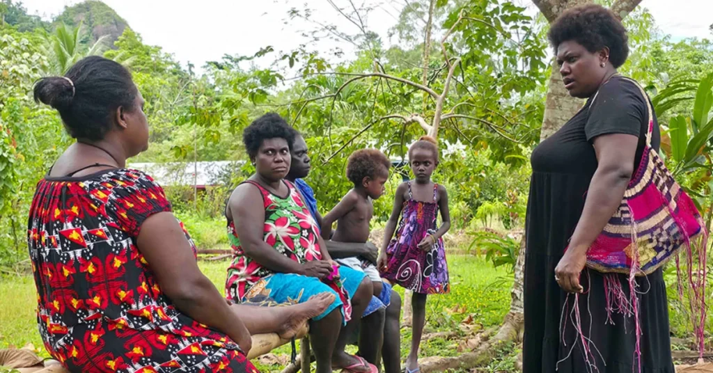 Theonila Roka Matbob consulting with mine-affected community women and children in Central Bougainville