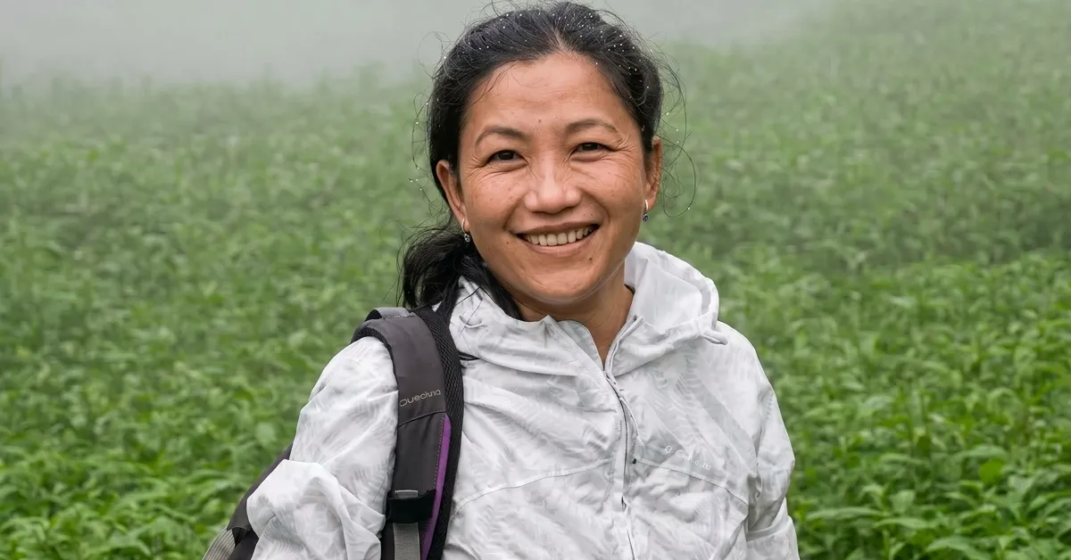 Dr Barkha Subba smiling in Darjeeling mountain tea landscape for Himalayan salamander conservation